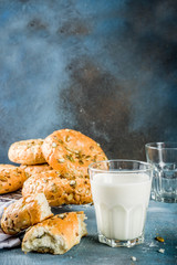 Healthy breakfast concept, home made cereal bagels with milk glass, on blue background copy space