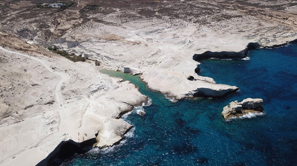 Aerial drone bird's eye view of iconic lunar volcanic white chalk iconic beach and caves of Sarakiniko, Milos island, Cyclades, Greece