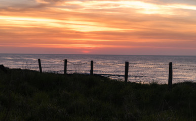 Pentland Sunset.  The sun setting over the Pentland Firth, Caithness, northern Scotland.