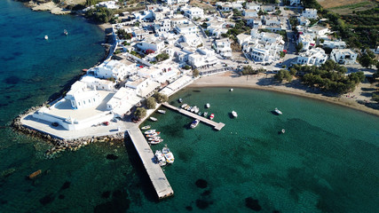 Aerial drone bird's eye view photo of picturesque fishing village of Polonia with traditional fishing boars docked next to island of Kimolos, Milos island, Cyclades, Greece