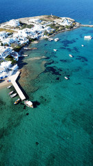 Aerial drone bird's eye view photo of picturesque fishing village of Polonia with traditional fishing boars docked next to island of Kimolos, Milos island, Cyclades, Greece