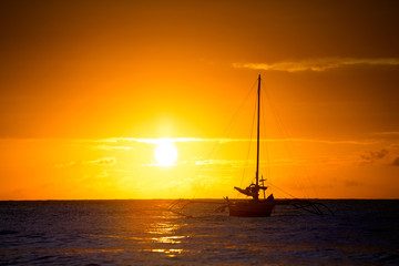 fishing boat at seascape with golden sunset