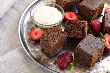 Chocolate sponge cake with strawberries and cream