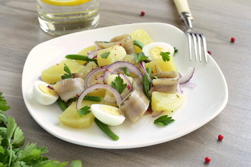 Salad with potatoes, anchovies, quail eggs, beans and onions