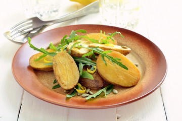 Baked potatoes with arugula and lemon zest