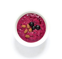 Tasty black currant smoothie with almonds and fresh berries, top view