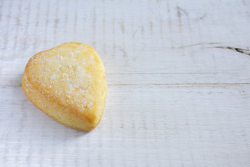 Heart of the cookie and wooden background.