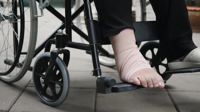 Patient with broken leg on wheelchair in hospital