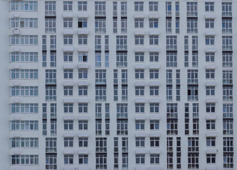 Fototapeta na wymiar background. defocusing. high-rise gray building of concrete and brick.