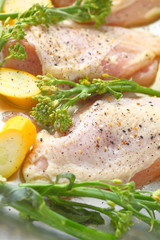 Chicken with yellow squash and broccolini sheet pan meal, seasoned and ready to bake
