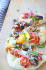 Vertical view of small pizza with various toppings