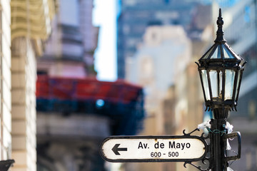 Street name sign on Avenida de Mayo (Buenos Aires, Argentina) on a street lamp