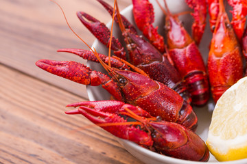 Closeup of boiled crayfish with lemon in a bowl