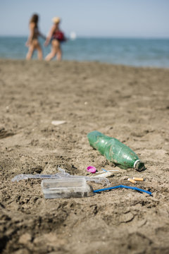 Plastic garbage left on a sandy beach.