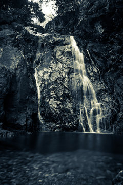 waterfall at river in dark colors