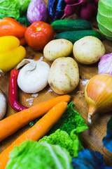 Top view fresh vegetables on the wooden counter of a small vegetable market.