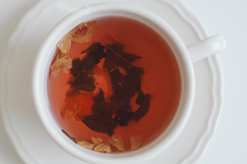Red herbal tea in white cup. Healthy hot drink