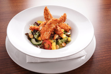 Deep Fried Chicken Goujons Served with a Medley Of Mediterranean Vegetables. 