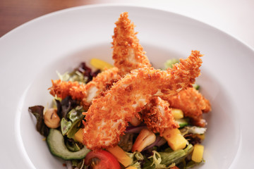 Deep Fried Chicken Goujons Served with a Medley Of Mediterranean Vegetables. 