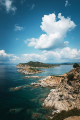 Beautiful top view of beautiful mediterranean sea and small island with green bushes on sunny summer day in Greece.