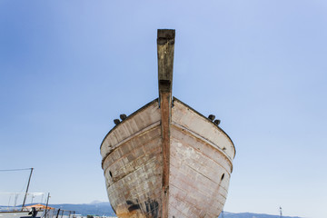 Perspective shot of front side fishing boat on ground for painting of trunk at Lesvos, Kalloni