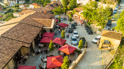 Arial shot of front entry in the castle of Kruja. Restaurants, people, shops, craftsman, antique.  © Igli
