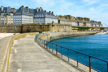 Fototapeta na wymiar The walled city of Saint-Malo, France, with granite residential buildings sticking out of the rampart.