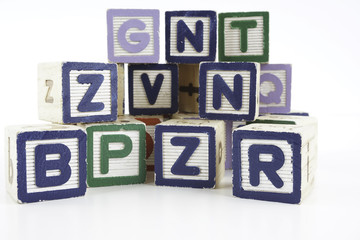 Colored wooden letter blocks on a white background with copy space
