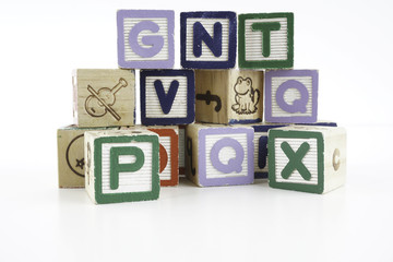Colored wooden letter blocks on a white background with copy space