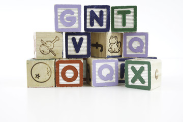 Colored wooden letter blocks on a white background with copy space