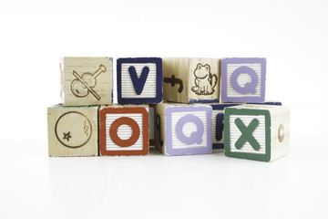 Colored wooden letter blocks on a white background with copy space
