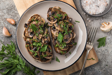 mushrooms garlic toasts on wooden cutting board