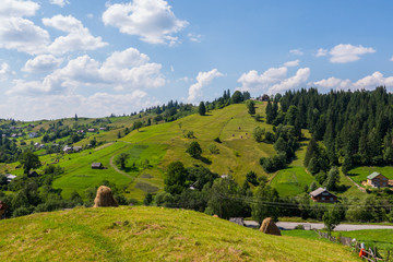 Naklejka na ściany i meble Carpathian village in the valleys with rarely poured down modest houses