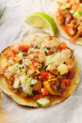 Mexican tacos with chili con carne, grilled sweet potatoes and grated cheese on white background. Text space