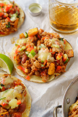Mexican tacos with chili con carne, grilled sweet potatoes and grated cheese on white background. Text space