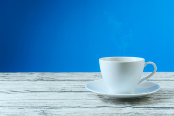 A cup of cofee on a wooden surface