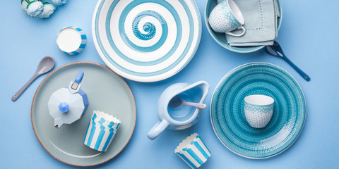 Blue pastel ceramic tableware crockery set on abstract background