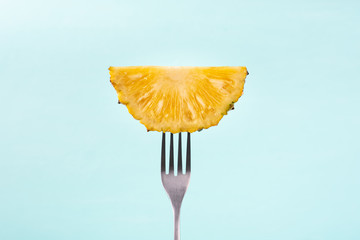 Slice pineapple on fork for eating, tropical fruit