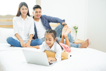 Fototapeta premium Young happy family relaxing at home, Family using laptop at home