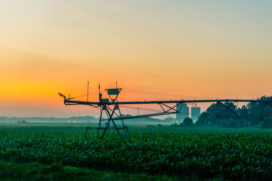 A center pivot irrigation system taken at sunrinse on a farm in rural delaware