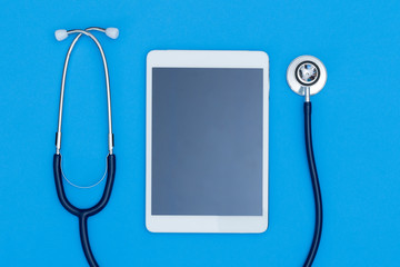 Medical equipment, Blue stethoscope and tablet on white background, Medical equipment, Stethoscope on blue background