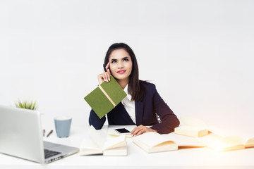 The business woman is working at office hour by laptop, mobile phone, and paperwork