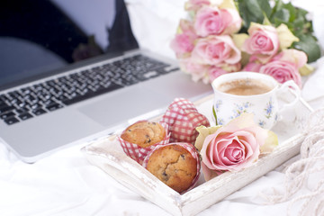 Coffee and bouquet of pink roses in bed, romance and coziness. Good morning. Breakfast in bed. Copy space.