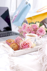 Coffee and bouquet of pink roses in bed, romance and coziness. Good morning. Breakfast in bed. Copy space,