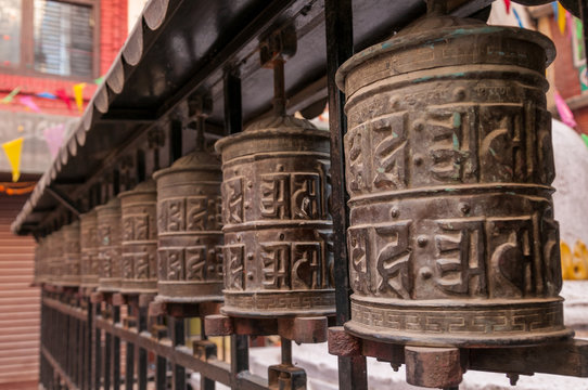 buddhist prayer wheels in a temple