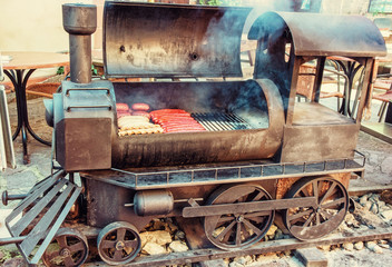 Barbecue grill with meat in shape of old steam locomotive