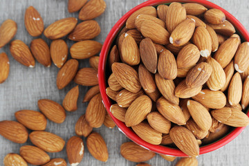 A ceramic bowl full of almonds