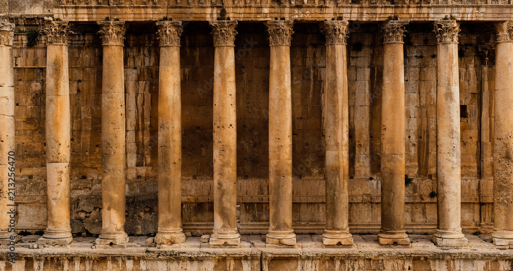 Wall mural frontal view of a colonnade - row of columns of an ancient roman temple ruin (bacchus temple in baal