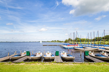 Water landscape with small sailboats in the harbor of a lake called Leekstermeer in Drenthe in the Netherlands - Powered by Adobe