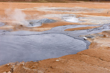 Hot gray mud pots in the geothermal area Hverir in Iceland